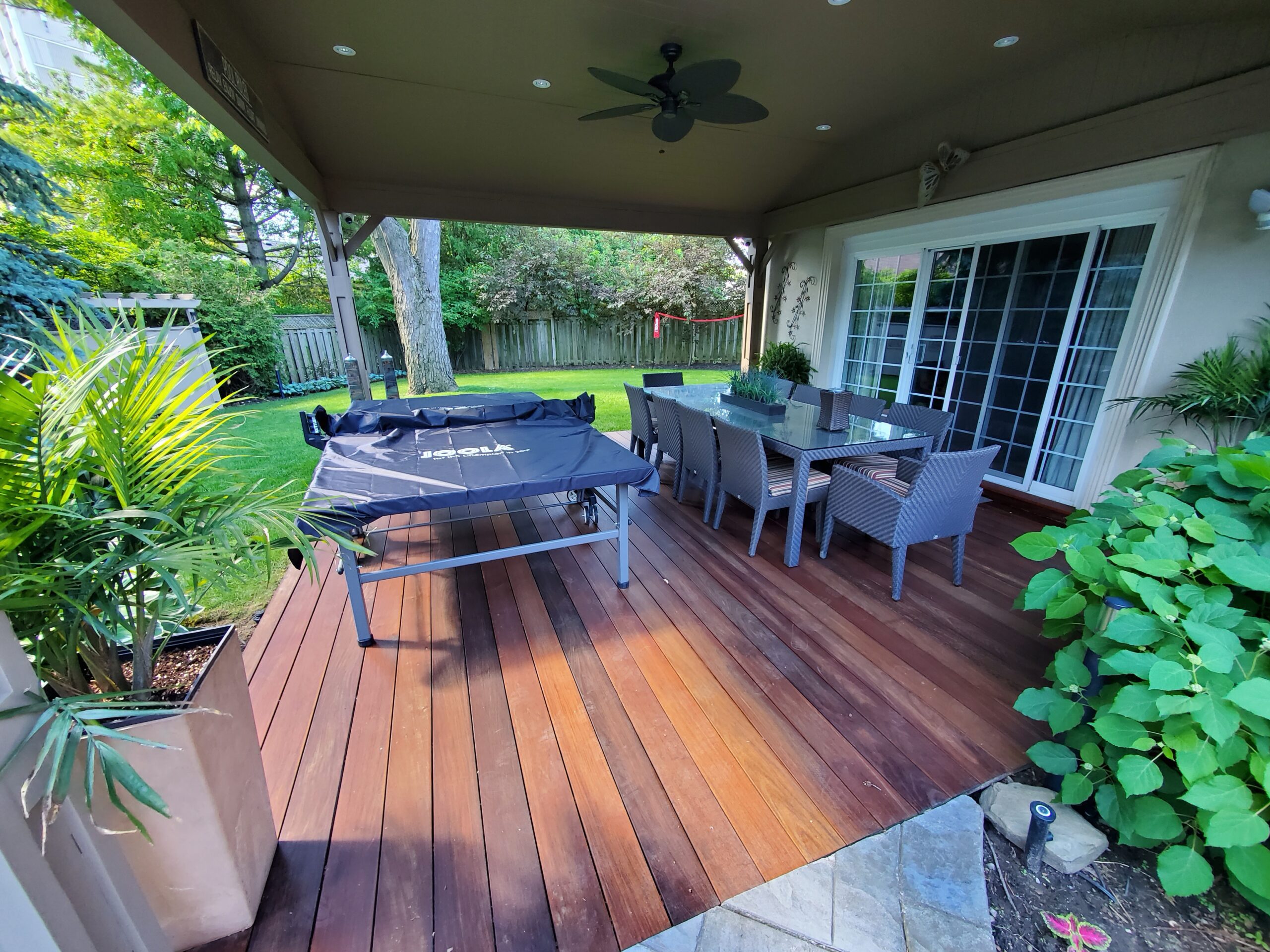 A wooden deck with a table and chairs.