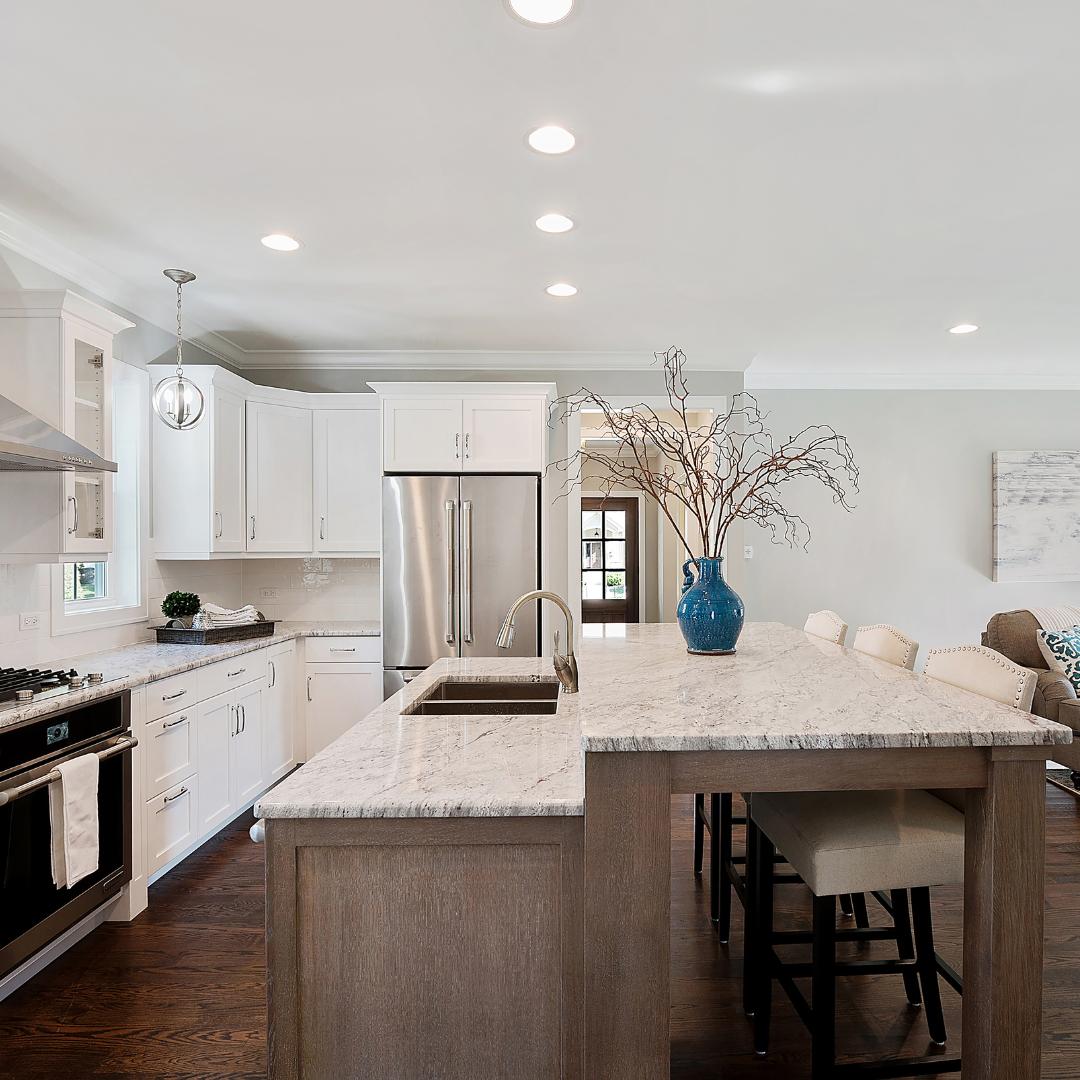 A kitchen with a large island featuring 5 Kitchen Upgrades.