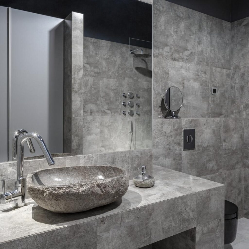 A bathroom with a sink and shower that has undergone renovations to enhance its functionality and aesthetics.