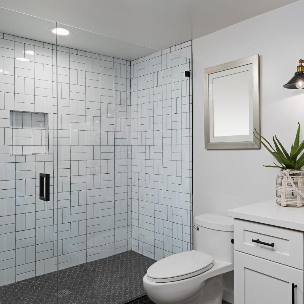 A renovated bathroom with a white tiled toilet and sink.