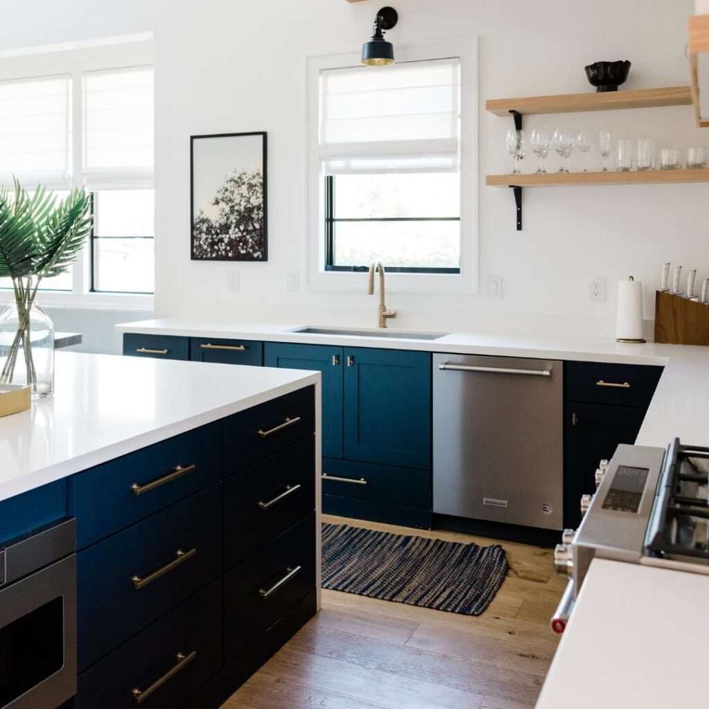A kitchen with blue cabinets and white countertops made even more stylish with innovative 5 Kitchen Upgrades.